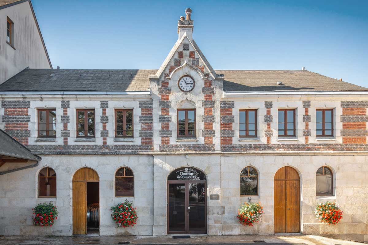 The Château de Sancerre estate building with its clock gable and flower boxes